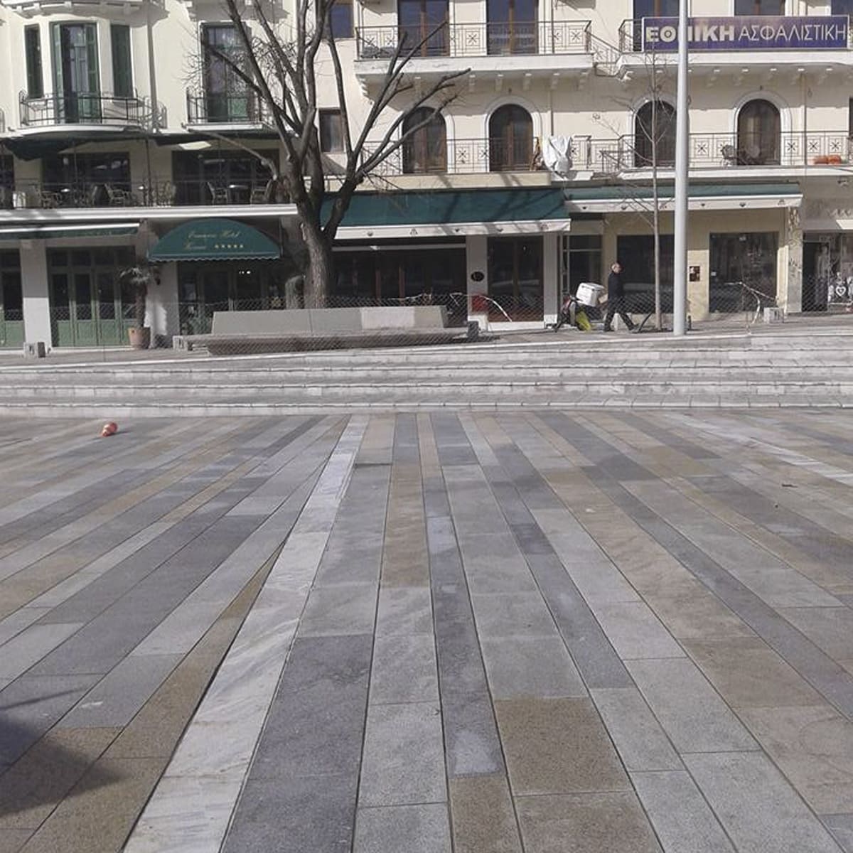 Striped stone paving in front of a classical city building