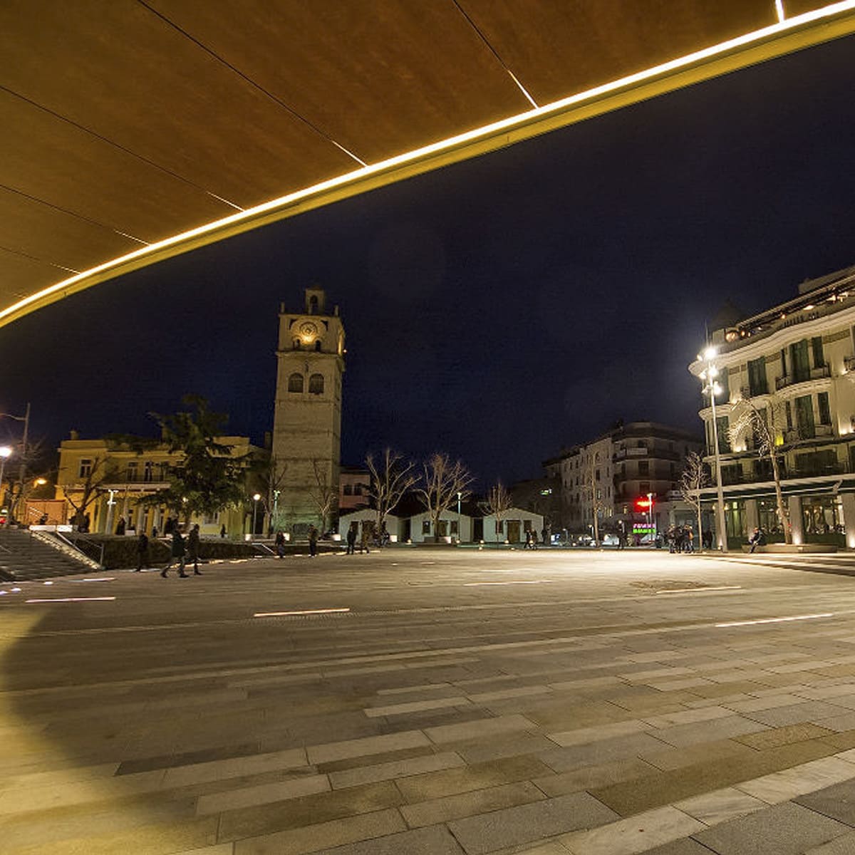 Night view of a paved square and historic clock tower