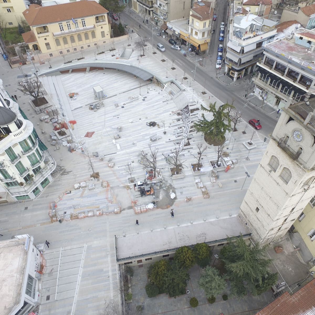 Aerial view of large-scale marble paving around a clock tower